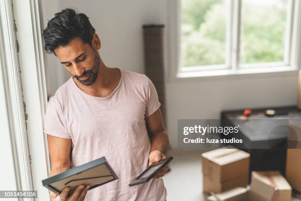 man moving into a new house - memories box stock pictures, royalty-free photos & images