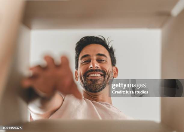 man moving into a new house - inside of box stock pictures, royalty-free photos & images