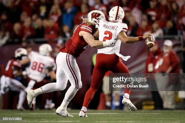 Andrew Van Ginkel of the Wisconsin Badgers hits Adrian Martinez of the Nebraska Cornhuskers as he throws a pass in the second quarter at Camp Randall...