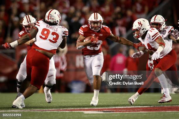 Jonathan Taylor of the Wisconsin Badgers runs with the ball in the third quarter against the Nebraska Cornhuskers at Camp Randall Stadium on October...