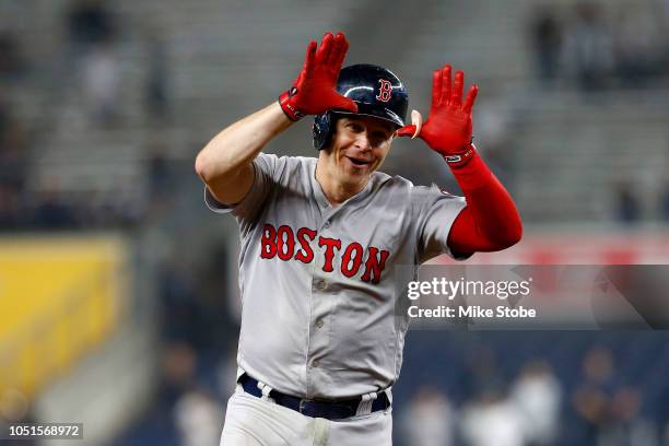 Brock Holt of the Boston Red Sox celebrates after hitting a two run home run against Austin Romine of the New York Yankees during the ninth inning in...