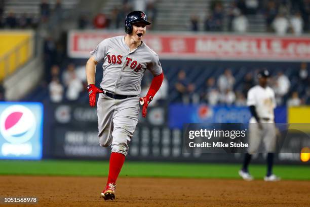 Brock Holt of the Boston Red Sox celebrates after hitting a two run home run against Austin Romine of the New York Yankees during the ninth inning in...