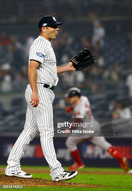 Austin Romine of the New York Yankees reacts after giving up a two run home run to Brock Holt of the Boston Red Sox during the ninth inning in Game...