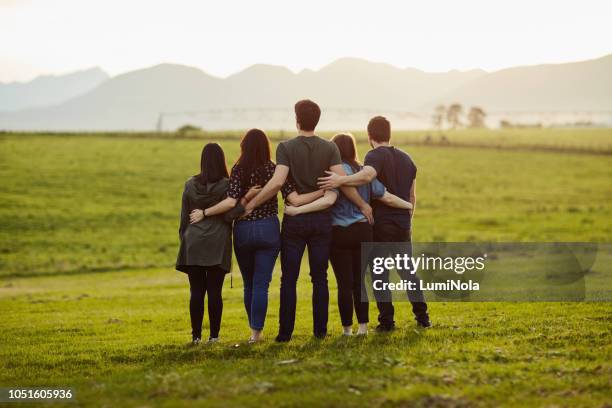 friends are the only ones who really have your back - arm around back stock pictures, royalty-free photos & images