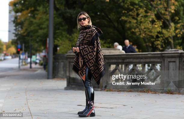 Aylin Koenig wearing a Jacquemus mini bag, Fendi Poncho, latex pants from topshop, Dior boots, Cartier jewelry and a Celine sunglasses on October 08,...