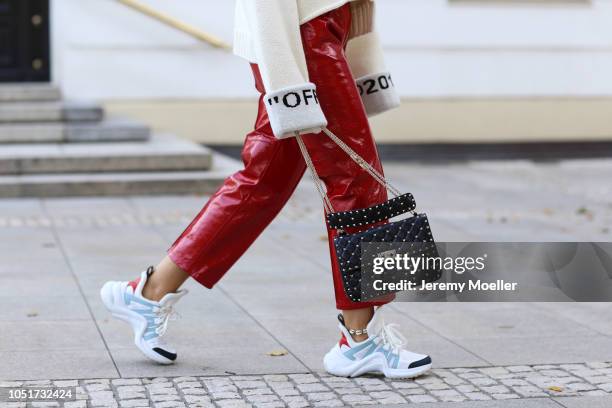 Janina Pfau wearing a Off White sweater, Louis Vuitton Archlight Sneaker, Valentino bag and pants from Petar Petrov on October 08, 2018 in Hamburg.