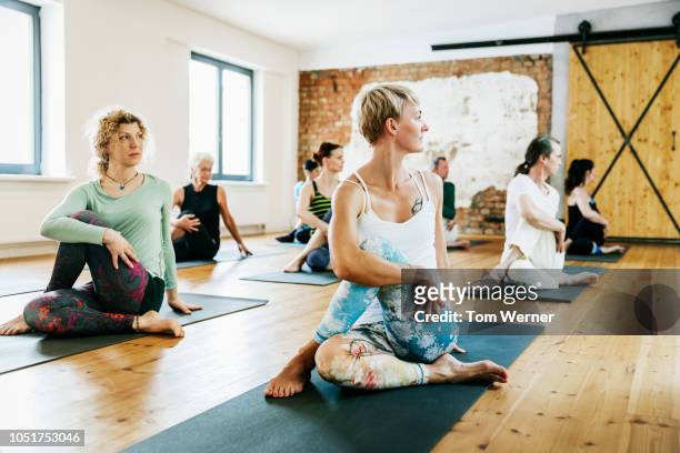 friends practicing yoga together - tom hale stock pictures, royalty-free photos & images