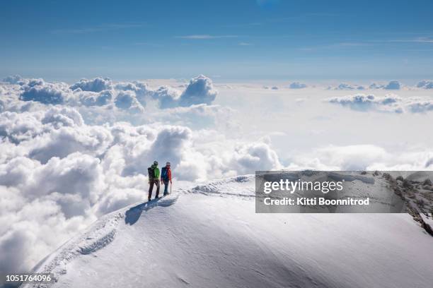 mountaineers walking on the ridge of weissmies, switzerland - mountain peak through clouds stock pictures, royalty-free photos & images