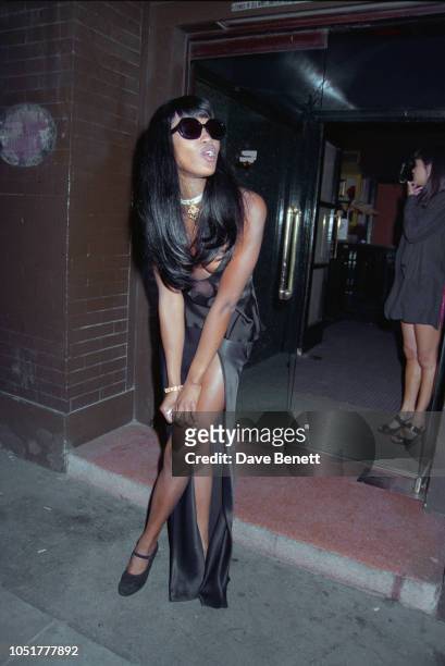 British supermodel Naomi Campbell, wearing black long silk dress and sunglasses, poses outside Tramp nightclub for the after party following the...
