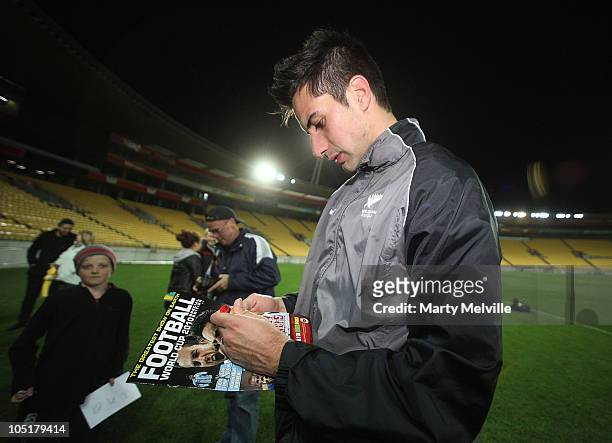 Rory Fallon of the All Whites signs autographs during a New Zealand All Whites training session at the Westpac Stadium on October 11, 2010 in...