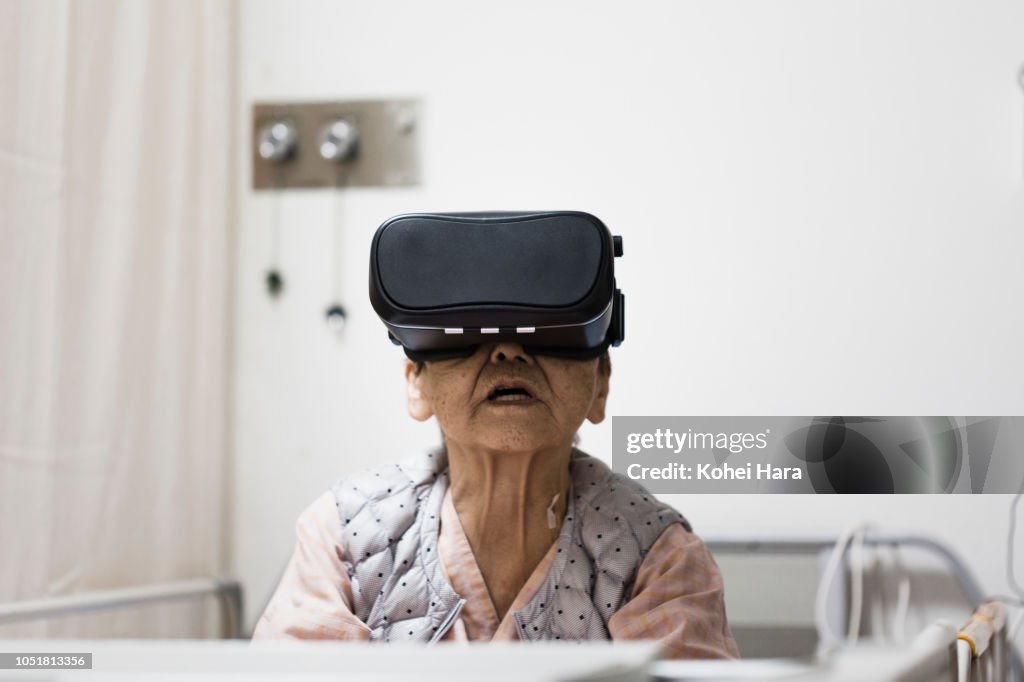 Senior woman in the hospital wearing a Virtual Reality headset