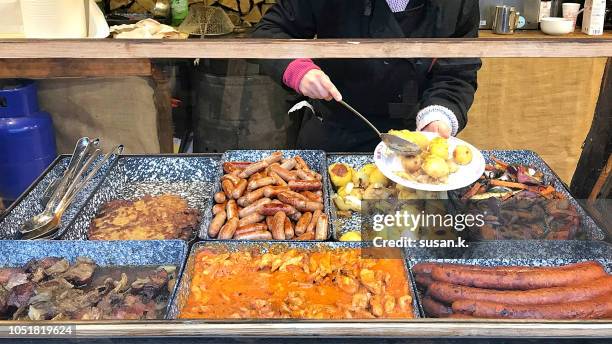 christmas stall selling potatoes and different types of sausages in budapest. - traditionally hungarian - fotografias e filmes do acervo