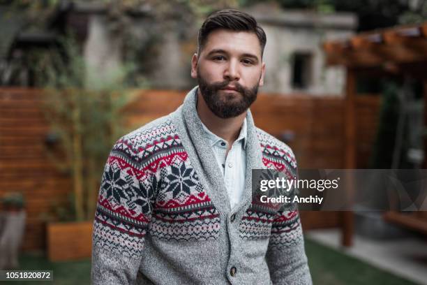 handsome man wearing warm clothes outdoors - cardigan sweater stock pictures, royalty-free photos & images