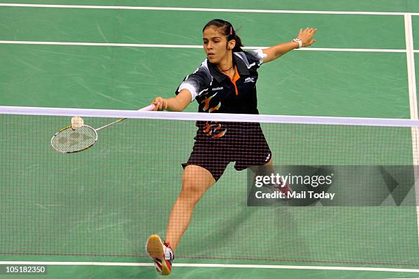 Indian's Saina Nehwal plays a shot against Wong Mew Choo during the Badminton Mixed Team at Siri Fort sports complex in New Delhi on October 8, 2010.
