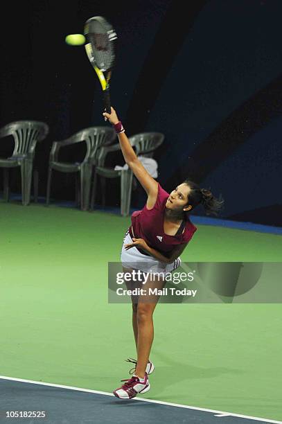 Indian Sania Mirza hits a shot against Australian Anastasia Rodionova in the Tennis Women's Singles during the Commonwealth Games at the R.K. Khanna...