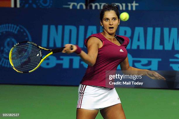 Indian Sania Mirza hits a shot against Australian Anastasia Rodionova in the Tennis Women's Singles during the Commonwealth Games at the R.K. Khanna...