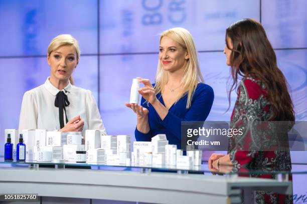 three women talking about cosmetics on a tv infomercial - television host stock pictures, royalty-free photos & images