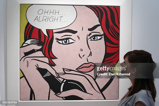 Christie's employee looks at a piece of work entitled 'Ohhh...Alright...', by Roy Lichtenstein, at Christie's auction house on October 11, 2010 in...