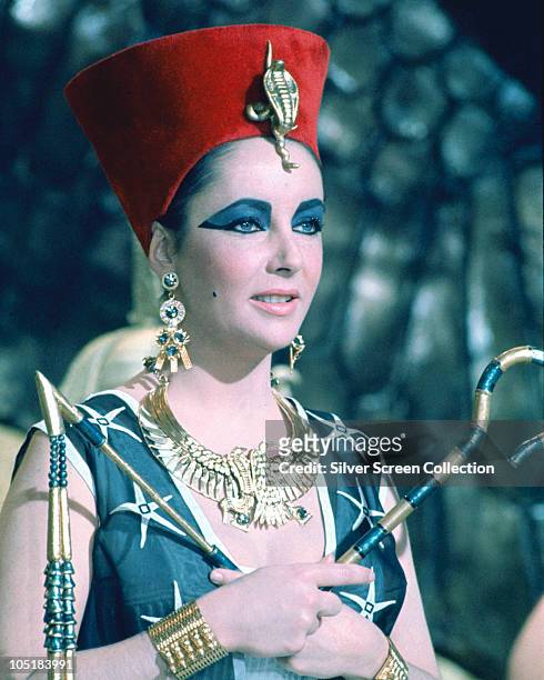 Actress Elizabeth Taylor as the titular Queen of Egypt in the film 'Cleopatra', 1963. She is holding the crook and flail which signify Egyptian...