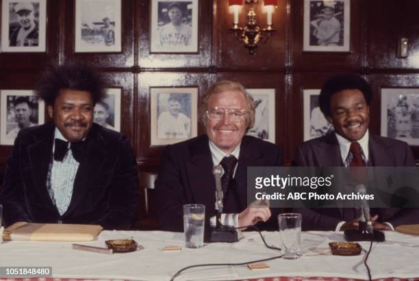 Don King, Roone Arledge, George Forman at press conference.