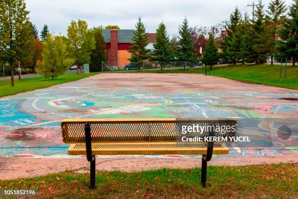An empty park with a map of Eveleth drawn on the ground in Eveleth, Minnesota on October 2, 2018. - As one drives into Eveleth, it is hard to ignore...