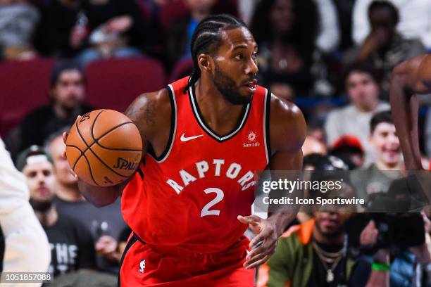 Toronto Raptors Forward Kawhi Leonard runs while dribbling the ball during the Brooklyn Nets versus the Toronto Raptors preseason game on October 10...