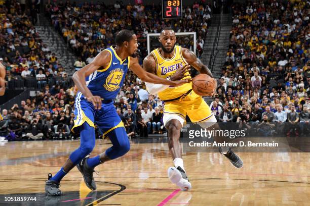 Kevin Durant of the Golden State Warriors defends against LeBron James of the Los Angeles Lakers during a pre-season game on October 10, 2018 at...