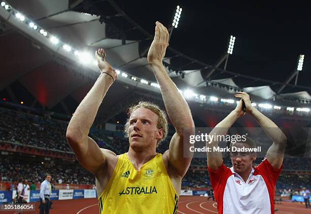 Gold medalist Steve Hooker of Australia celebrates with bronze medalist Max Eaves of England after the men's pole vault at Jawaharlal Nehru Stadium...