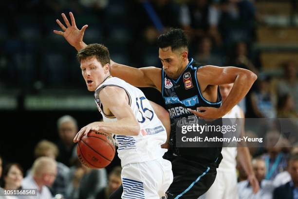 Cameron Gliddon of the Bullets drives against Tai Wesley of the Breakers during the round one NBL match between the New Zealand Breakers and the...