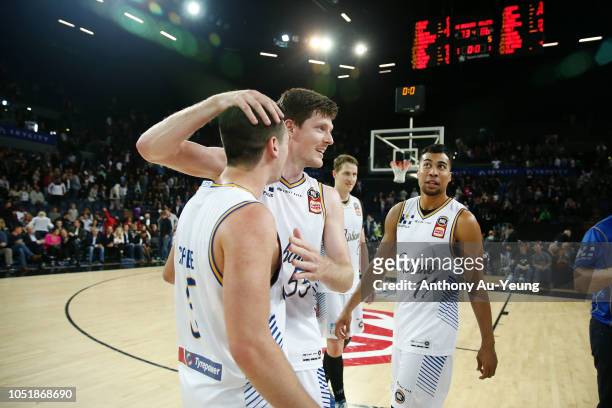 Cameron Gliddon and Jason Cadee of the Bullets celebrate after winning the round one NBL match between the New Zealand Breakers and the Brisbane...