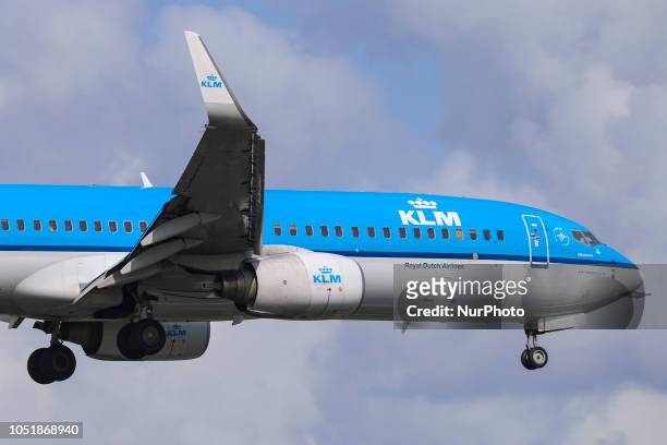 Royal Dutch Airlines Boeing 737-800 landing at Amsterdam Schiphol Airport during a cloudy day, The Netherlands. The registration of the airliner is...