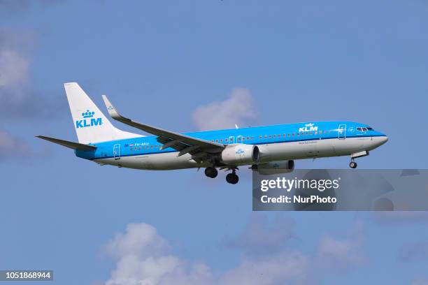 Royal Dutch Airlines Boeing 737-800 landing at Amsterdam Schiphol Airport during a cloudy day, The Netherlands. The registration of the airliner is...