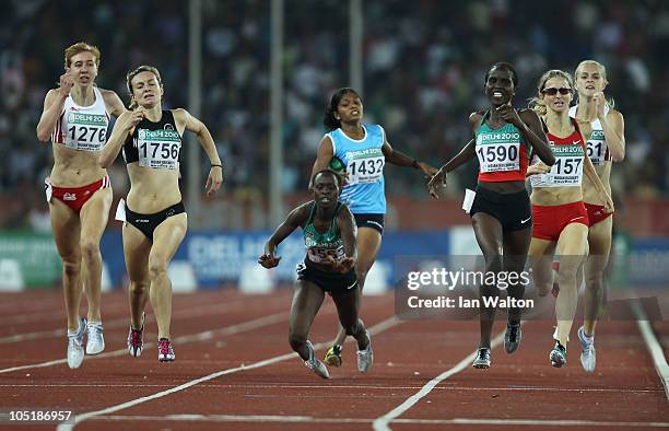 Winny Chebet of Kenya falls as Nancy Lan'gat of Kenya races to the finish line to claim gold in front of silver medalist Nikki Hamblin of New Zealand...