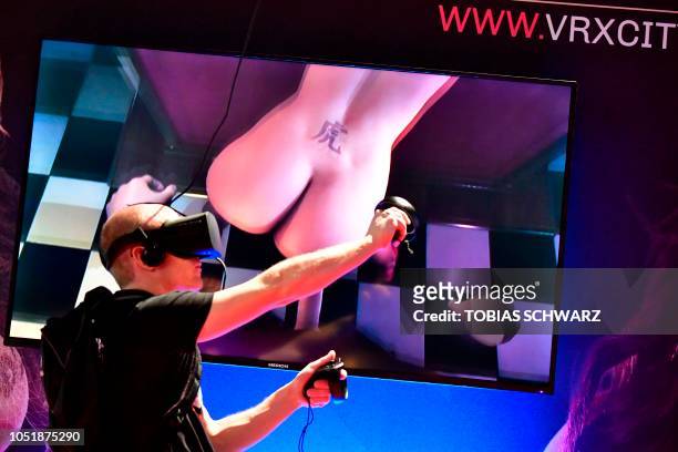 Man tries an erotic VR game at the Venus Fair for Erotic Entertainment and Lifestyle during the fair's opening day in Berlin on October 11, 2018.