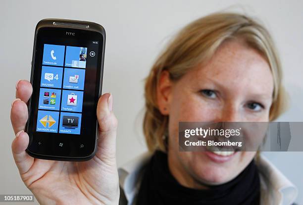 Alexandra Huerter-Waasem, a Deutsche Telekom AG employee, shows the main menu of the new Microsoft Corp. Windows Phone 7 operating system, on the...