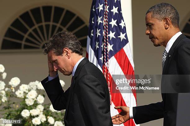 President Barack Obama departs with U.S. Treasury Secretary Timothy Geithner after delivering a statement in the Rose Garden of the White House...