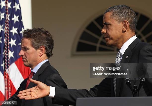 President Barack Obama departs with U.S. Treasury Secretary Timothy Geithner after delivering a statement in the Rose Garden of the White House...