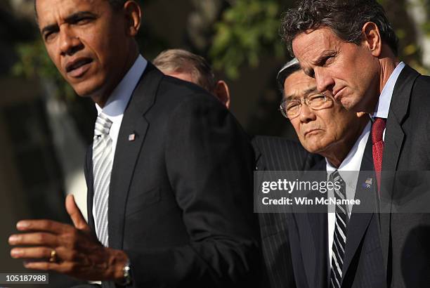 Treasury Secretary Timothy Geithner and Transportation Secretary Norman Mineta listen as U.S. President Barack Obama makes a statement in the Rose...