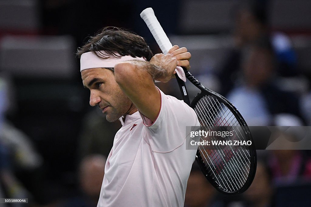 Federer Using Head Racket Switzerland's Roger Federer ties his headband during the men's ...