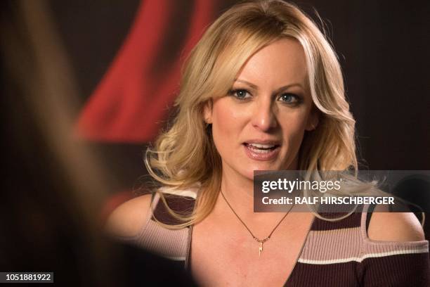 Stormy Daniels, the porn star who claims to have slept with US President Donald Trump over a decade ago, talks with a journalist during an interview...