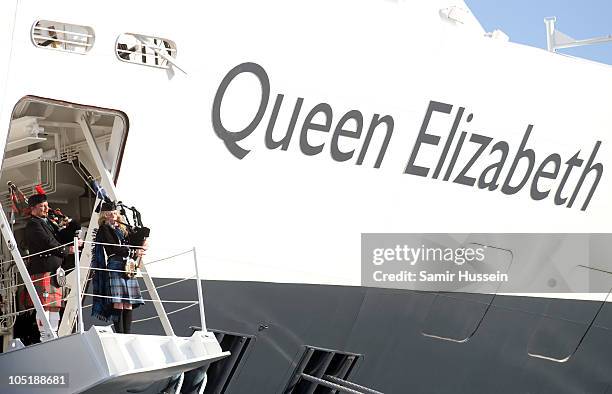 Bagpipers play during the ceremony to name Cunard's new cruise-liner Queen Elizabeth II in Southampton Docks on October 11, 2010 in Southampton,...