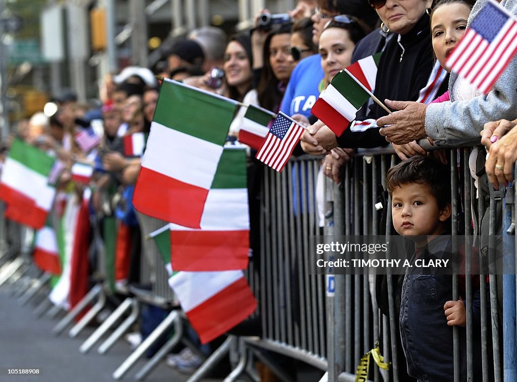 A young boy watches trhough the barricad