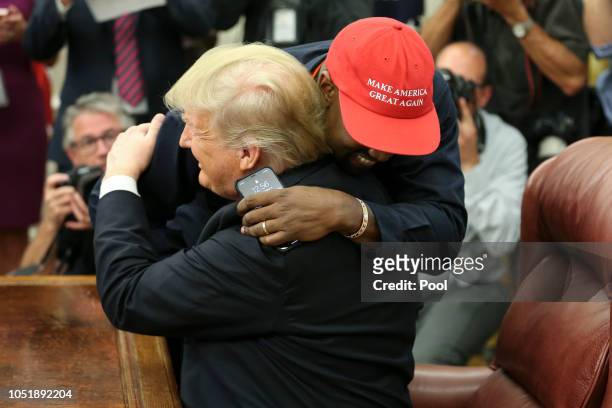 President Donald Trump hugs rapper Kanye West during a meeting in the Oval office of the White House on October 11, 2018 in Washington, DC.