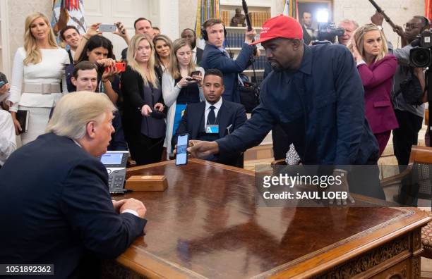 President Donald Trump meets with rapper Kanye West in the Oval Office of the White House in Washington, DC, on October 11, 2018.