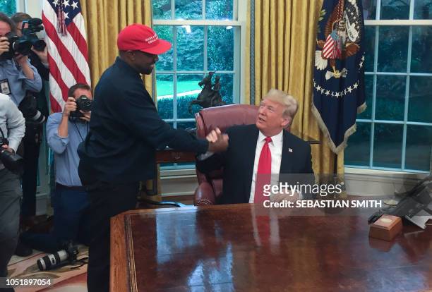President Donald Trump meets with rapper Kanye West in the Oval Office of the White House in Washington, DC, October 11, 2018.