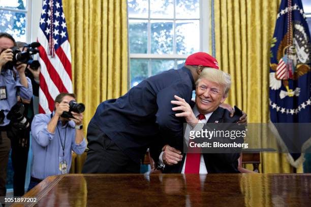 Rapper Kanye West, left, hugs U.S. President Donald Trump during a meeting in the Oval Office of the White House in Washington, D.C., U.S., on...