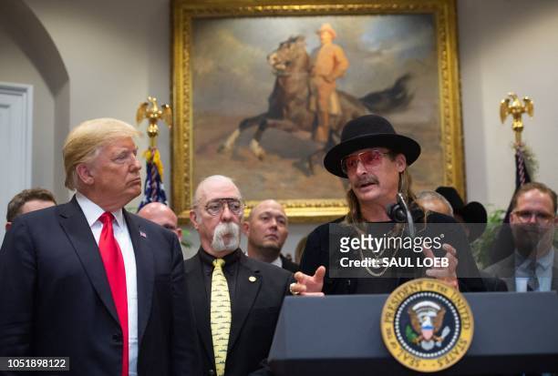 President Donald Trump shakes hands with musician Kid Rock after signing the Hatch-Goodlatte Music Modernization Act, a bipartisan bill aimed at...