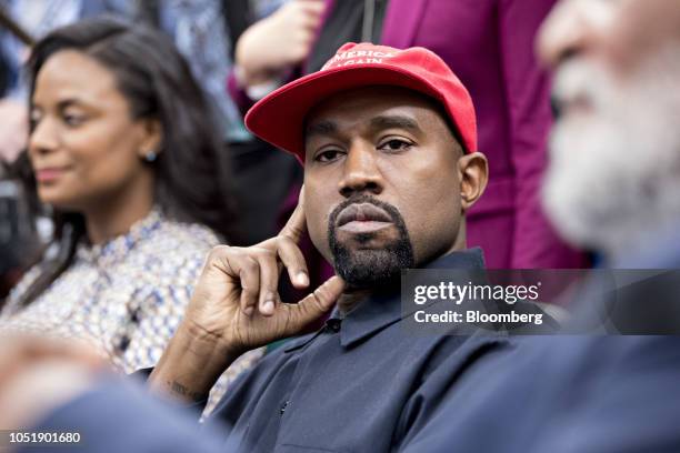 Rapper Kanye West listens during a meeting with U.S. President Donald Trump, not pictured, in the Oval Office of the White House in Washington, D.C.,...