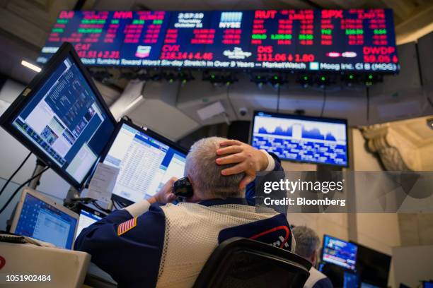 Trader works on the floor of the New York Stock Exchange in New York, U.S., on Thursday, Oct. 11, 2018. U.S. Stocks fell for a sixth day, extending...