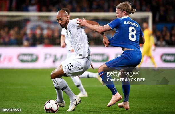 France's midfielder Steven N'zonzi vies with Iceland's midfielder Birkir Bjarnason during the friendly football match between France and Iceland at...